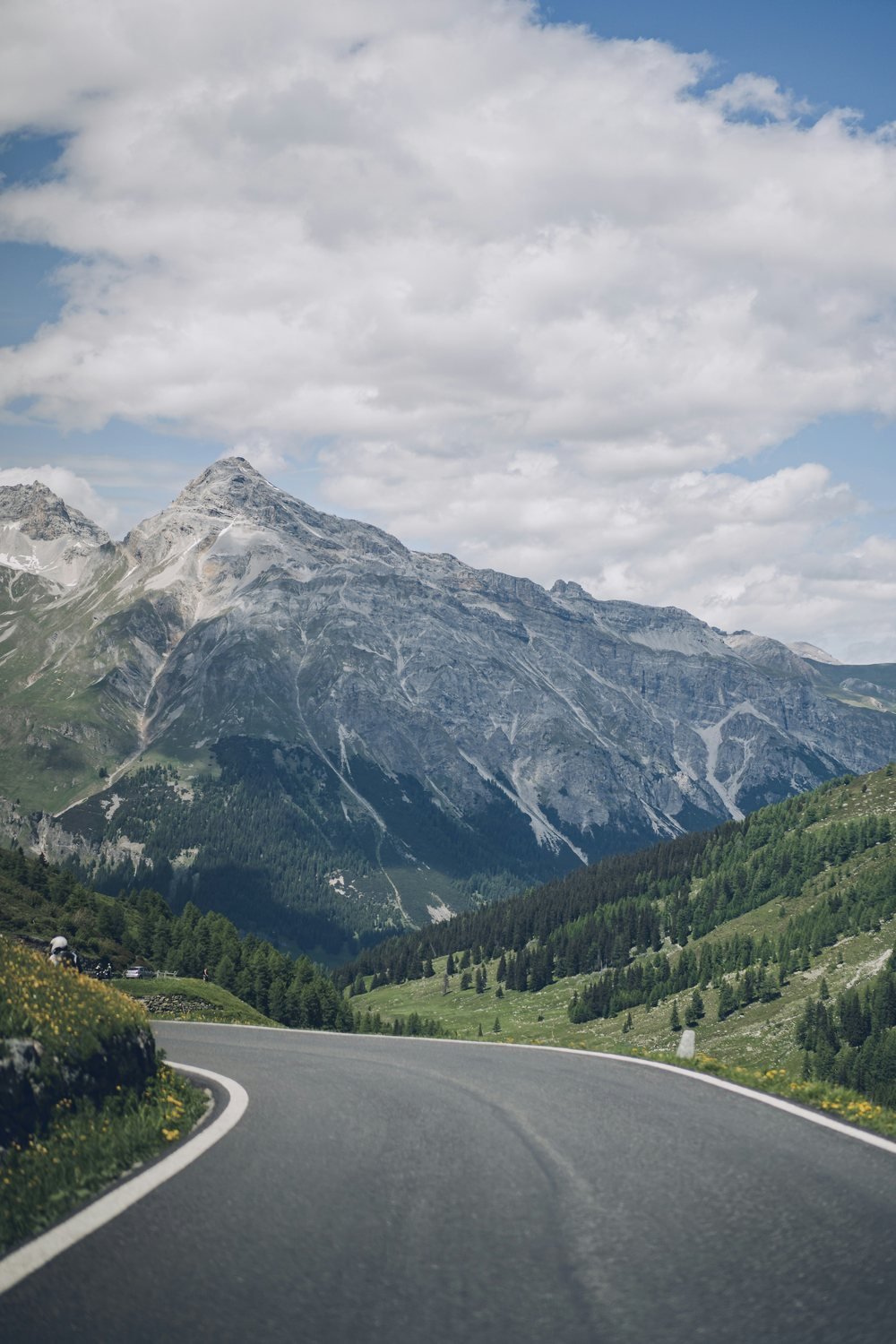 A mountain road winding through the Swiss Alps